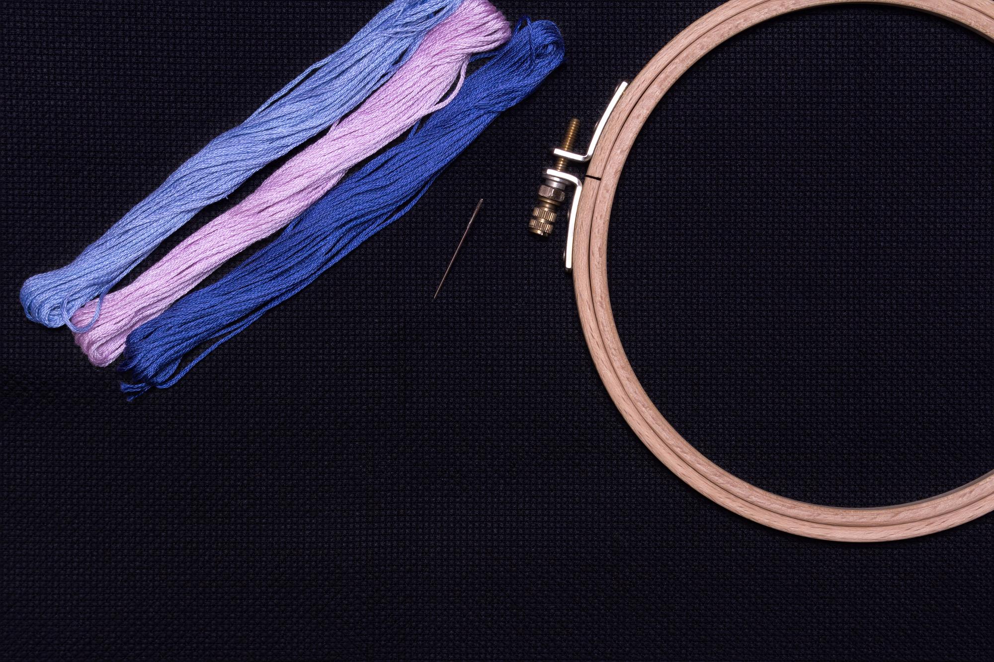 Close-up modern embroidery hoop with neon threads