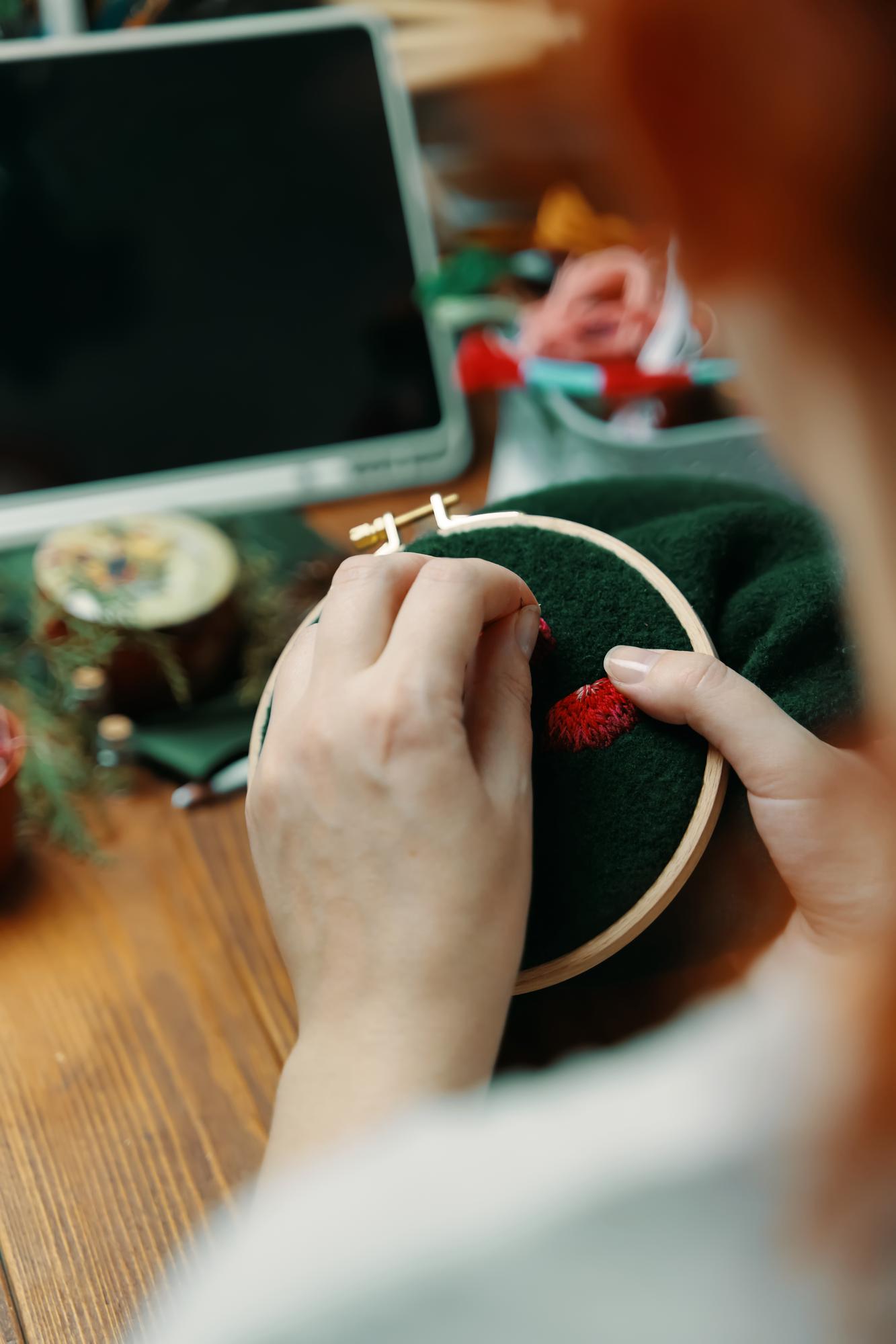 Workshop hands teaching embroidery technique